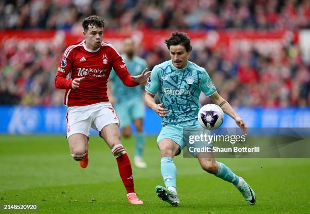 Hugo Bueno of Wolverhampton Wanderers runs with the ball under pressure from Neco Williams of Nottingham Forest during the Premier League match...