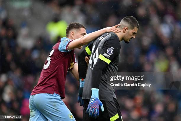Arijanet Muric of Burnley is consoled by his teammate Maxime Esteve after scoring an own goal during the Premier League match between Burnley FC and...