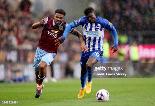 Lyle Foster of Burnley battles for possession with Carlos Baleba of Brighton & Hove Albion during the Premier League match between Burnley FC and...