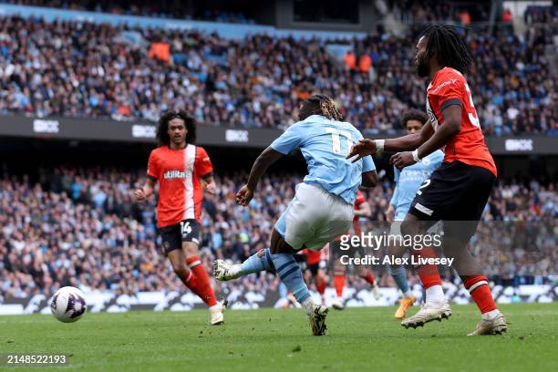 Jeremy Doku of Manchester City scores his team's fourth goal during the Premier League match between Manchester City and Luton Town at Etihad Stadium...