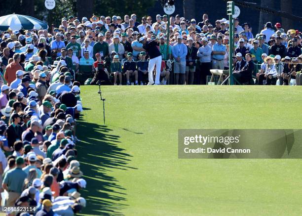 Rickie Fowler of The United States plays his tee shot on the first hole during the third round of the 2024 Masters Tournament at Augusta National...