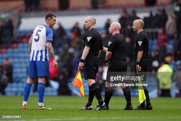 Lewis Dunk of Brighton & Hove Albion speaks with Match Referee Simon Hooper and Assistant Referees Adrian Holmes and Simon Long after the draw in the...