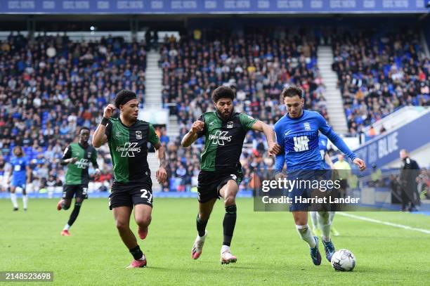 Lee Buchanan of Birmingham City is challenged by Milan van Ewijk and Ellis Simms of Coventry City during the Sky Bet Championship match between...