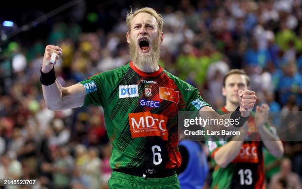 Matthias Musche of Magdeburg celebrates after winning the REWE Final4 match between SC Magdeburg and Füchse Berlin at Lanxess Arena on April 13, 2024...