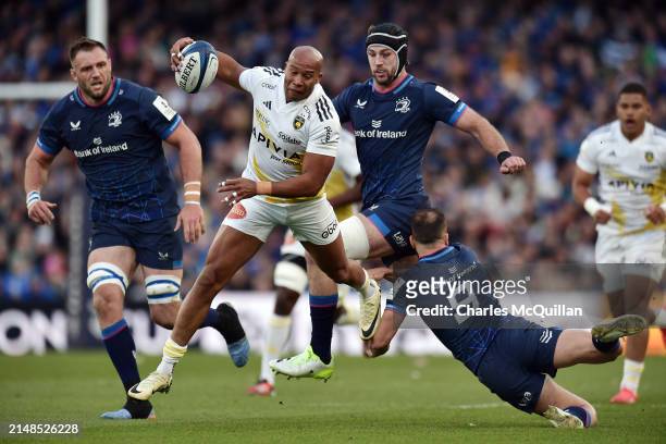 Teddy Thomas of Stade Rochelais runs with the ball under pressure from Jamison Gibson-Park of Leinster Rugby during the Investec Champions Cup...