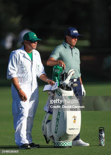 Rickie Fowler of The United States prepares to play his second shot on the 15th hole with his caddie Ricky Romano during the second round of the 2024...