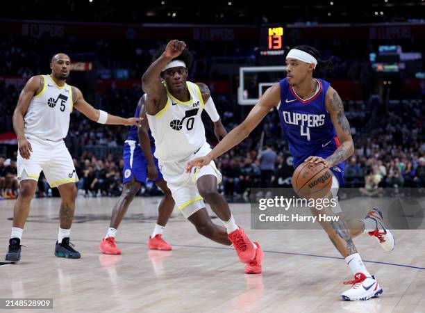 Brandon Boston Jr. #4 of the LA Clippers drives to the basket past Taylor Hendricks and Talen Horton-Tucker of the Utah Jazz during a 110-109 loss to...