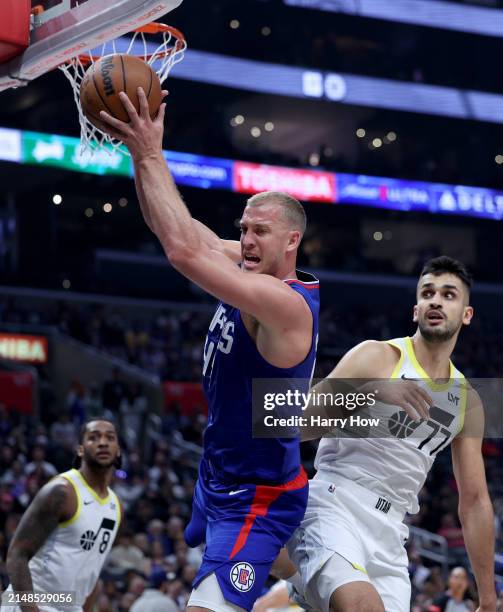 Mason Plumlee of the LA Clippers grabs a rebound in front of Omer Yurtseven and Brice Sensabaugh of the Utah Jazz during a 110-109 loss to the Utah...