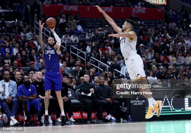 Amir Coffey of the LA Clippers shoots a three pointer in front of Omer Yurtseven of the Utah Jazz during a 110-109 loss to the Utah Jazz at...