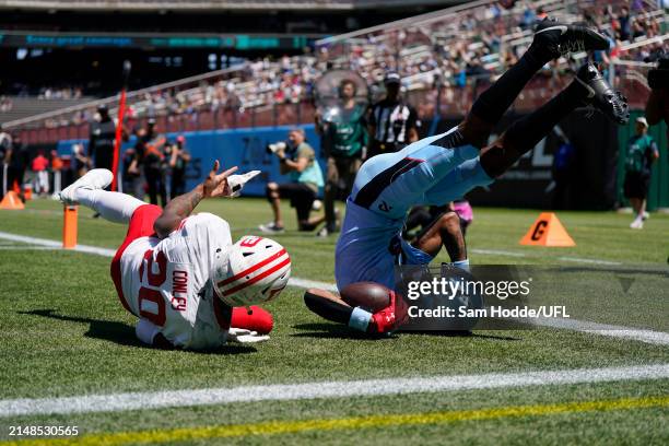 Tyler Vaughns of the Arlington Renegades catches a pass for a touchdown while defended by Gareon Conley of the DC Defenders during the second quarter...