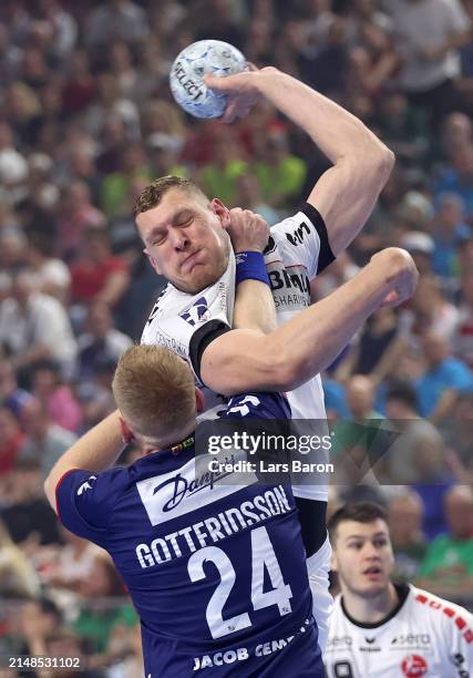 Dainis Kristopans of Melsung is challenged by Jim Gottfridsson of Flensburg during the REWE Final4 match between SG Flensburg-Handewitt and MT...