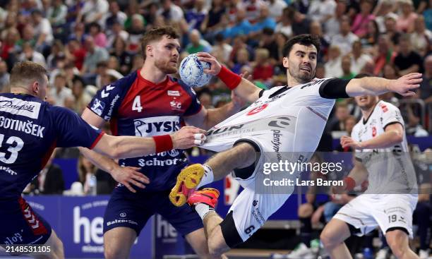 Erik Balensiaga of Melsungen is challenged by Blaz Blagotinsek of Flensburg during the REWE Final4 match between SG Flensburg-Handewitt and MT...