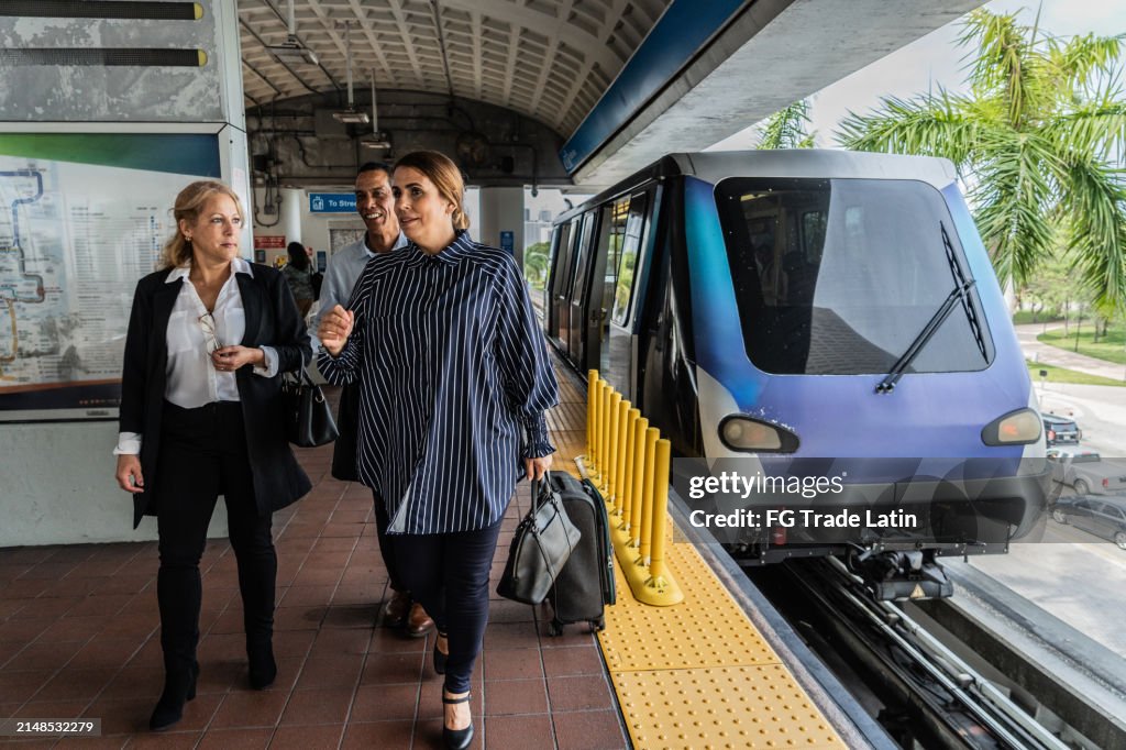 Business colleagues talking and walking on the subway station