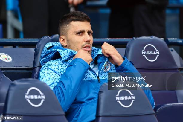 Rodri of Manchester City speaks sits on the substitutes bench prior to the Premier League match between Manchester City and Luton Town at Etihad...