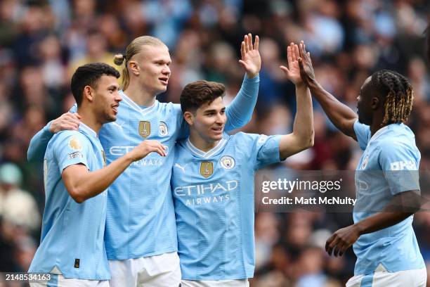 Matheus Nunes, Erling Haaland, Bernardo Silva and Jeremy Doku of Manchester City celebrate after the teams first goal, an own goal scored by Daiki...