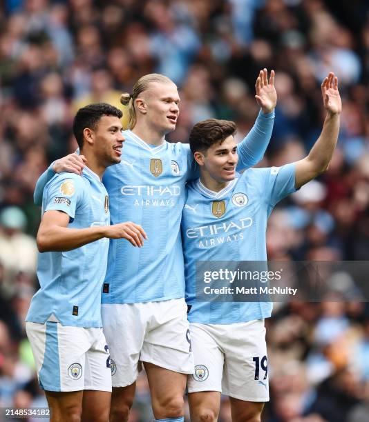 Matheus Nunes, Erling Haaland and Bernardo Silva of Manchester City celebrate after the teams first goal, an own goal scored by Daiki Hashioka during...