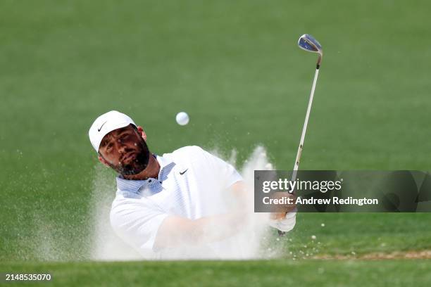 Scottie Scheffler of the United States plays his shot from the bunker on the second hole during the third round of the 2024 Masters Tournament at...