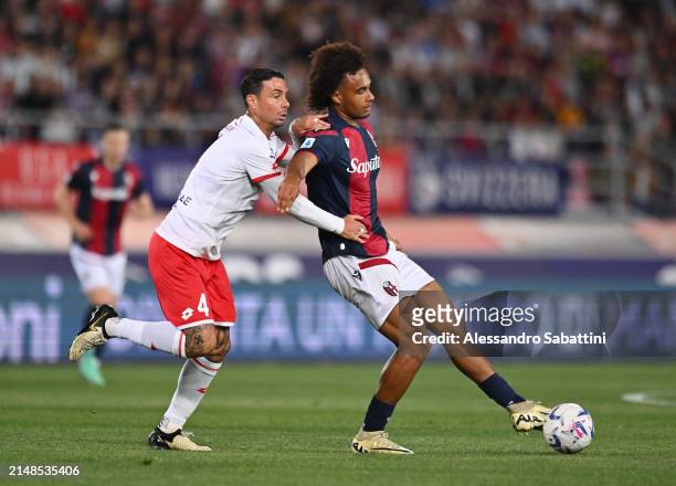 Joshua Zirkzee of Bologna FC passes the ball whilst under pressure from Armando Izzo of AC Monza during the Serie A TIM match between Bologna FC and...