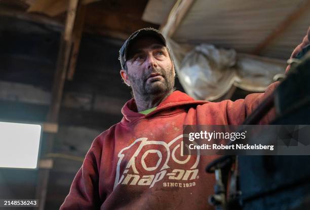 Mechanic removes the clutch assembly of a 1984 Case tractor April 5, 2024 at the LaBerge Brothers Farm in Charlotte, Vermont.