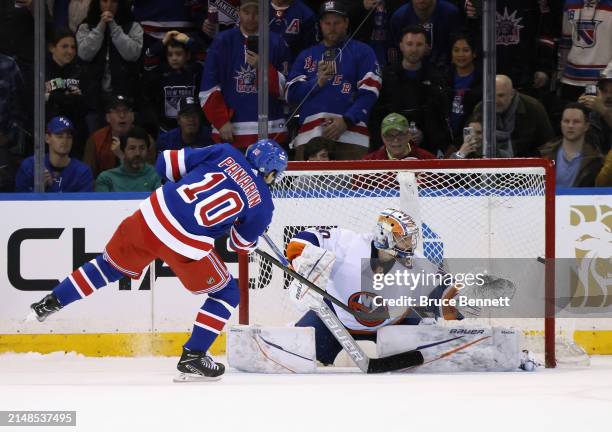 Artemi Panarin of the New York Rangers scores in the shootout against Ilya Sorokin of the New York Islanders at Madison Square Garden on April 13,...