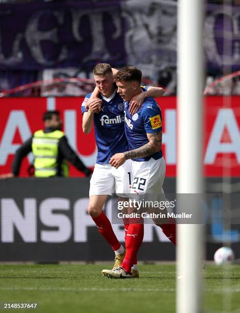 Alexander Bernhardsson of Holstein Kiel celebrates with teammate Nicolai Remberg after scoring the team's fourth goal during the Second Bundesliga...