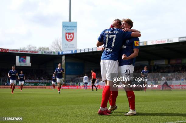 Timo Becker of Holstein Kiel celebrates with teammate Jann-Fiete Arp after scoring the team's third goal during the Second Bundesliga match between...