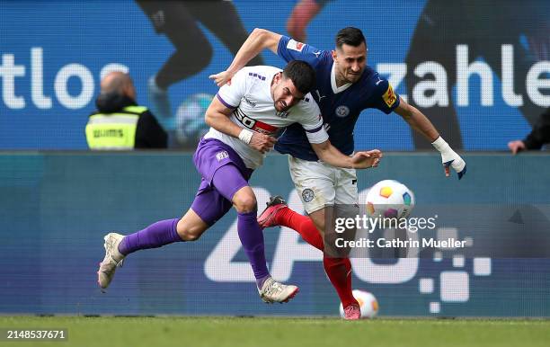 Steven Skrzybski of Holstein Kiel is challenged by Athanasios Androutsos of VfL Osnabruck during the Second Bundesliga match between Holstein Kiel...