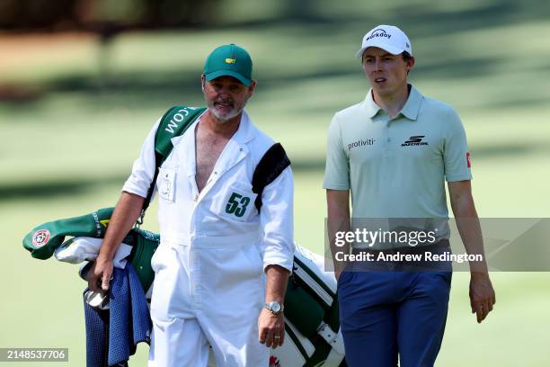 Matt Fitzpatrick of England and caddie Billy Foster walk across the 10th hole during the third round of the 2024 Masters Tournament at Augusta...