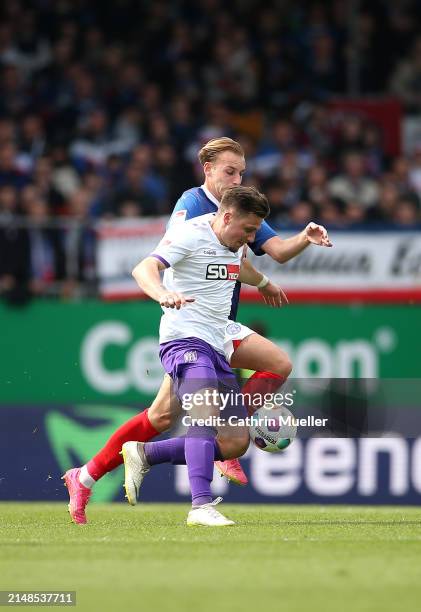 Erik Engelhardt of VfL Osnabruck is challenged by Timo Becker of Holstein Kiel during the Second Bundesliga match between Holstein Kiel and VfL...