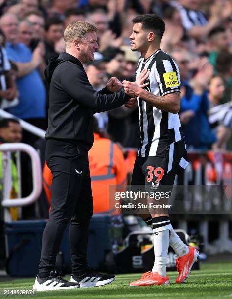 Newcastle United player Bruno Guimaraes and head coach Eddie Howe share a joke after Guimaraes is Substituted during the Premier League match between...