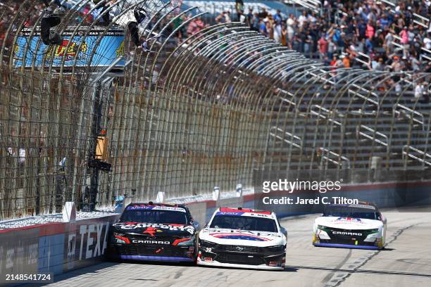 Sam Mayer, driver of the Carolina Carports Chevrolet, crosses the finish line ahead of Ryan Sieg, driver of the Sci Aps Ford, to win the NASCAR...