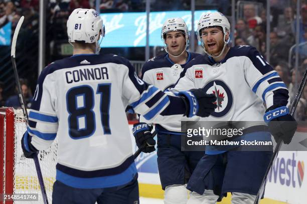 Gabriel Vilardi of the Winnipeg Jets celebrates with Kyle Connor and Sean Monahan after scoring against the Colorado Avalanche in the first period at...