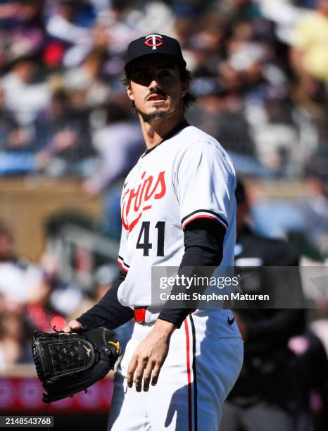 Joe Ryan of the Minnesota Twins walks to the dugout after pitching in the fifth inning of the game against the Cleveland Guardians at Target Field on...