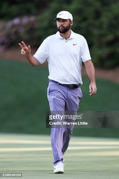 Scottie Scheffler of the United States reacts after making eagle on the 13th green during the third round of the 2024 Masters Tournament at Augusta...