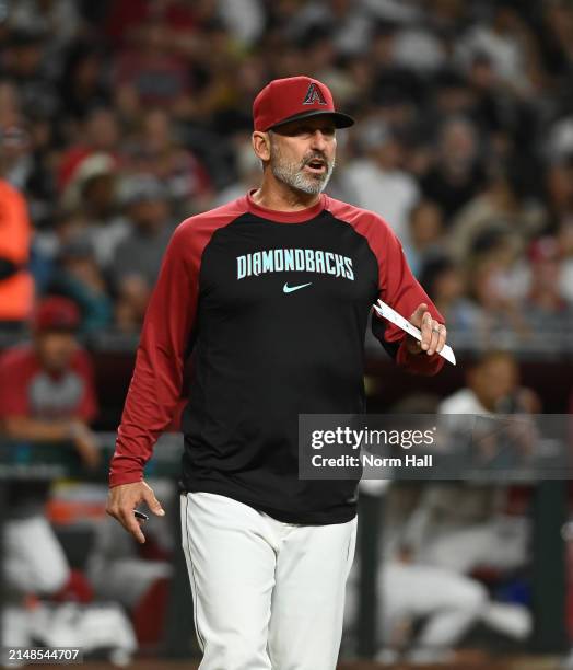 Manager Torey Lovullo of the Arizona Diamondbacks walks out to the pitchers mound against the St Louis Cardinals at Chase Field on April 12, 2024 in...