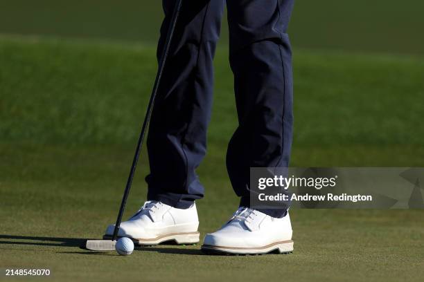 Detail view as Cameron Smith of Australia putts on the 18th green during the third round of the 2024 Masters Tournament at Augusta National Golf Club...