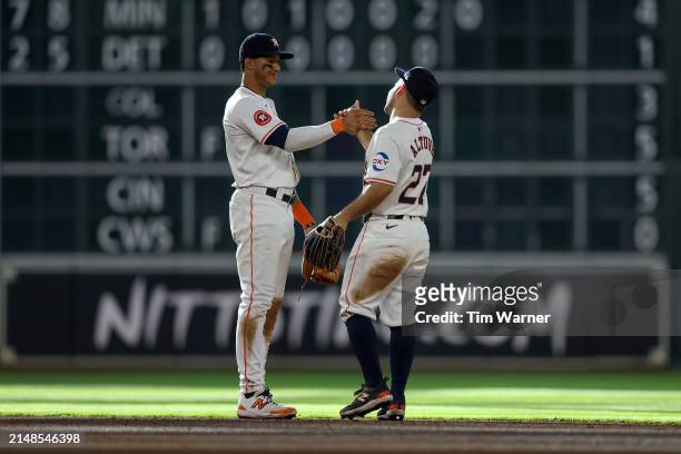 Jeremy Peña of the Houston Astros celebrates with Jose Altuve after defeating the Texas Rangers at Minute Maid Park on April 13, 2024 in Houston,...