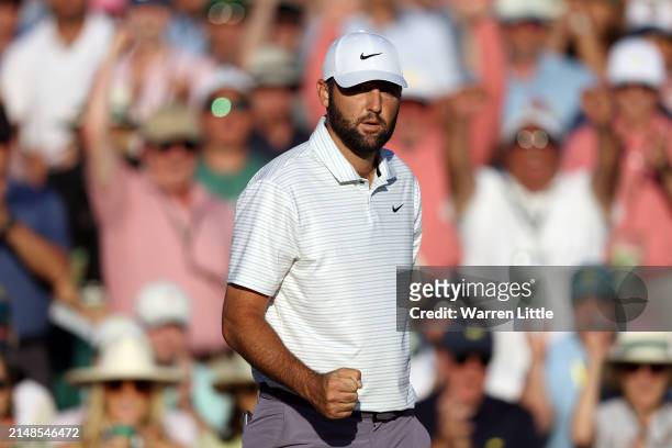 Scottie Scheffler of the United States reacts after making birdie on the 18th green during the third round of the 2024 Masters Tournament at Augusta...