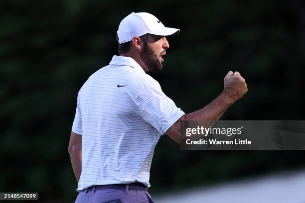 Scottie Scheffler of the United States reacts after making eagle on the 13th green during the third round of the 2024 Masters Tournament at Augusta...