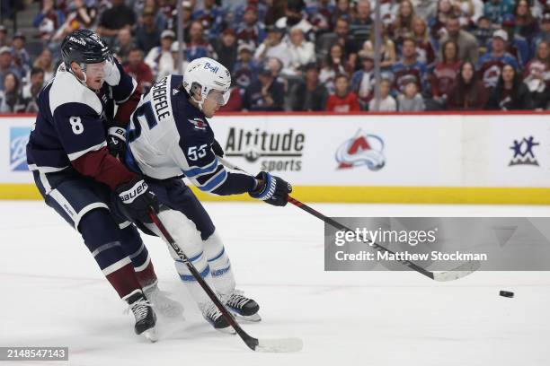 Mark Scheifele of the Winnipeg Jets fires a shot against Cale Makar of the Colorado Avalanche in the first period at Ball Arena on April 13, 2024 in...