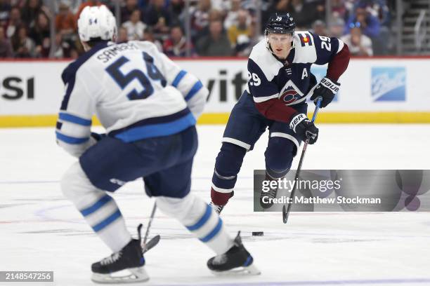 Nathan MacKinnon of the Colorado Avalanche advances the puck against the Winnipeg Jets in the second period at Ball Arena on April 13, 2024 in...