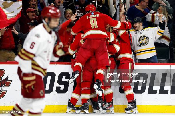 Members of the Denver Pioneers celebrate a goal by teammate Jared Wright against the Boston College Eagles in the second period during the NCAA Men's...