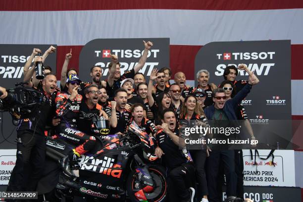Maverick Vinales of Spain and Aprilia Racing celebrates victory with the team on the podium during the MotoGP Of The Americas - Sprint on April 13,...