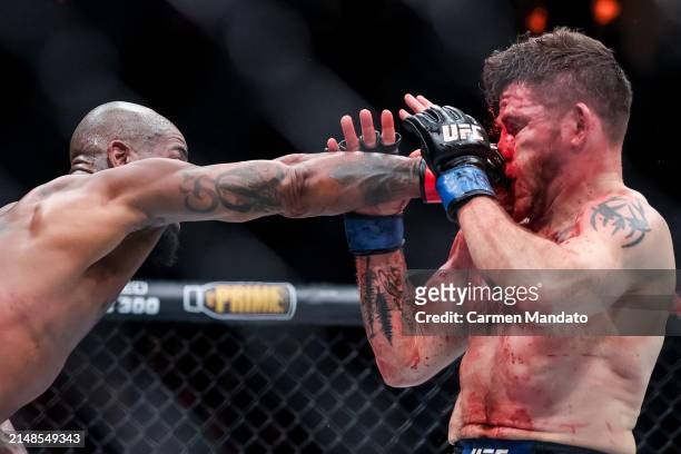 Bobby Green and Jim Miller exchange strikes during their lightweight fight at T-Mobile Arena on April 13, 2024 in Las Vegas, Nevada.