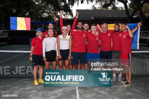 Team Romania poses for a group photo with a "Qualified" banner after defeating Ukraine in the Billie Jean King Cup Qualifier match at Racquet Park...