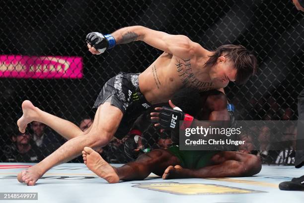 Diego Lopes of Brazil punches Sodiq Yusuff of Nigeria in a featherweight fight during the UFC 300 event at T-Mobile Arena on April 13, 2024 in Las...