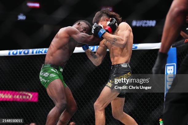 Diego Lopes of Brazil punches Sodiq Yusuff of Nigeria in a featherweight fight during the UFC 300 event at T-Mobile Arena on April 13, 2024 in Las...