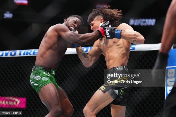 Diego Lopes of Brazil punches Sodiq Yusuff of Nigeria in a featherweight fight during the UFC 300 event at T-Mobile Arena on April 13, 2024 in Las...