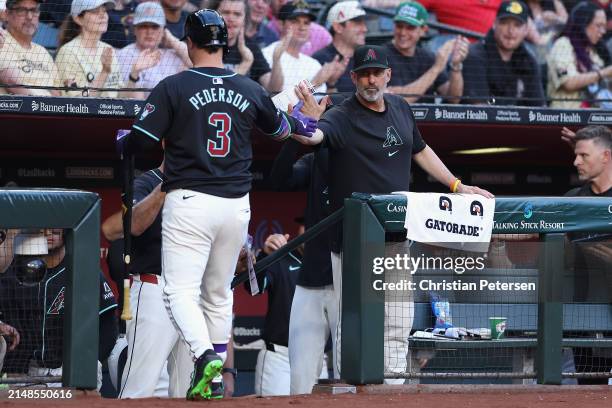 Manager Torey Lovullo of the Arizona Diamondbacks high fives Joc Pederson after a sacrifice fly against the St. Louis Cardinals during the first...