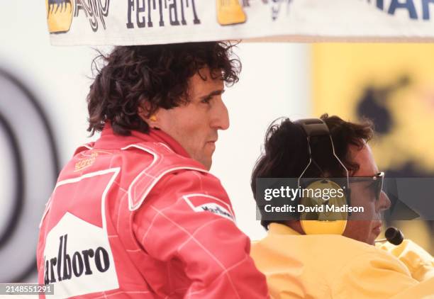 Alain Prost, #27, of the Ferrari team, works with team engineers during the 1991 United States F1 Grand Prix held on March 10, 1991 in Phoenix,...